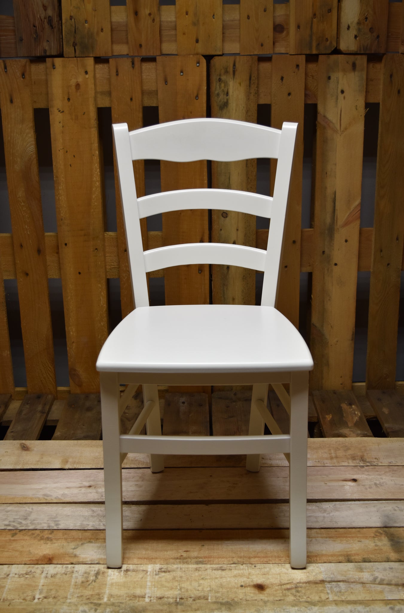 Stock NEVE model chairs lacquered in ice white, wooden seat