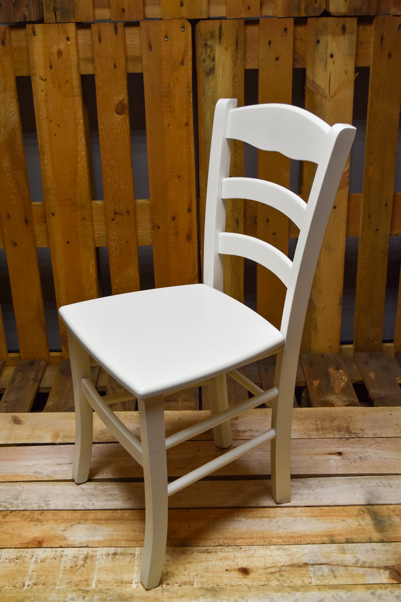 Stock NEVE model chairs lacquered in ice white, wooden seat