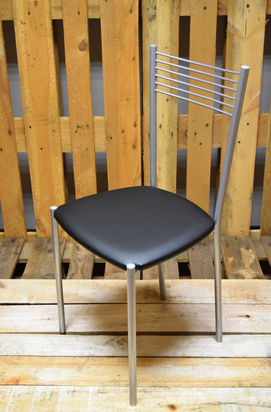 Stock chairs model MA10 in aluminum color with black padded seat